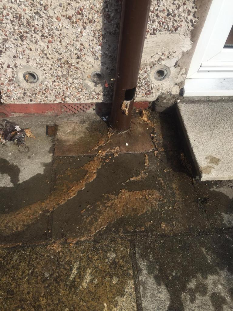 Blocked soil pipe outside a house on the Wirral that has not yet been unblocked
